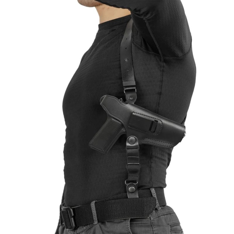 Black leather shoulder holster worn under the arm with TT Tokarev pistol, side view