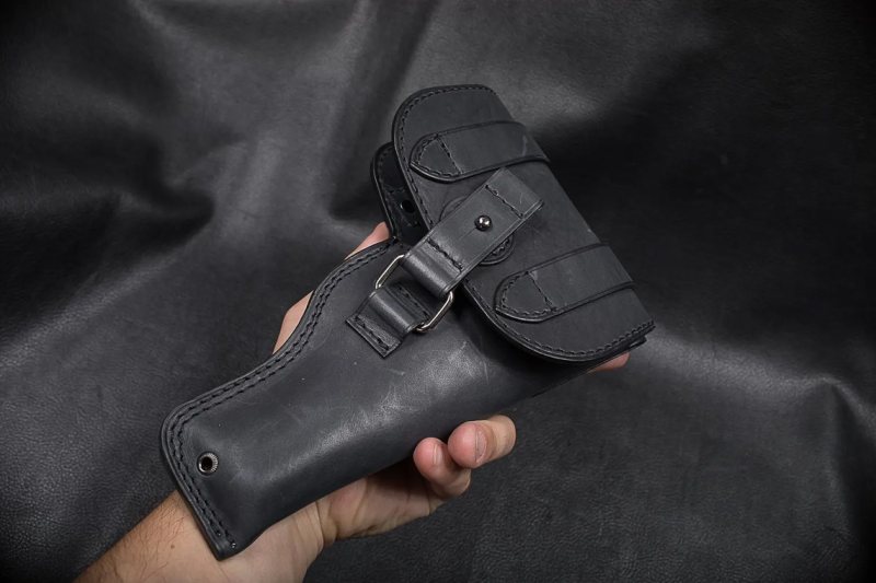 Black Leather Patrol Flap Holster held in hand showing full cover flap and enclosed field carry design