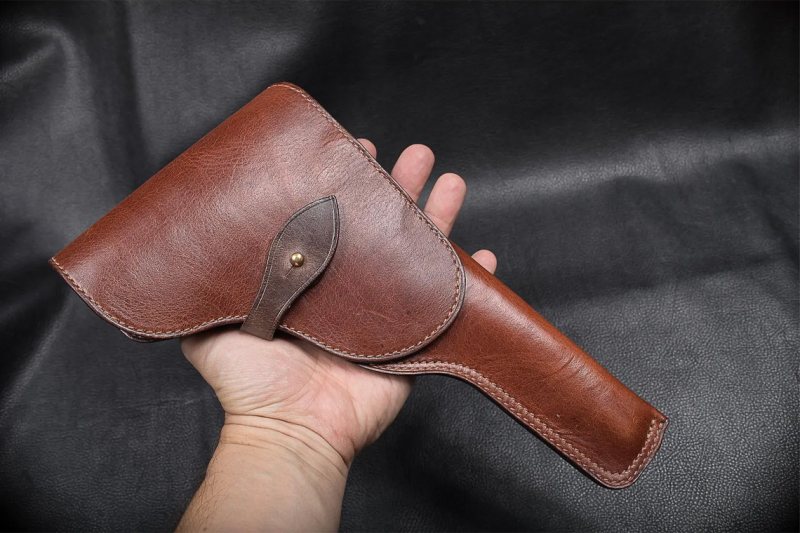 Brown Leather Flap Hunting Holster held in hand showing full front profile and flap closure