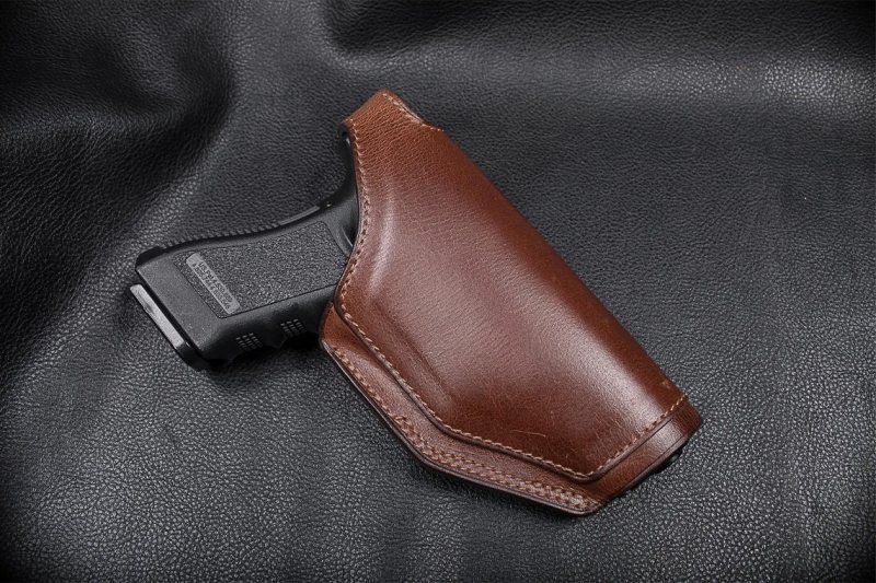 Brown Leather OWB Hunting Holster front view with pistol grip visible on black background
