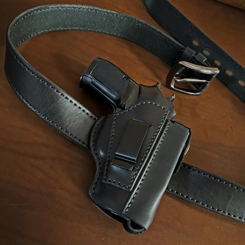 Black leather CZ 82 holster attached to belt with integrated magazine pouch