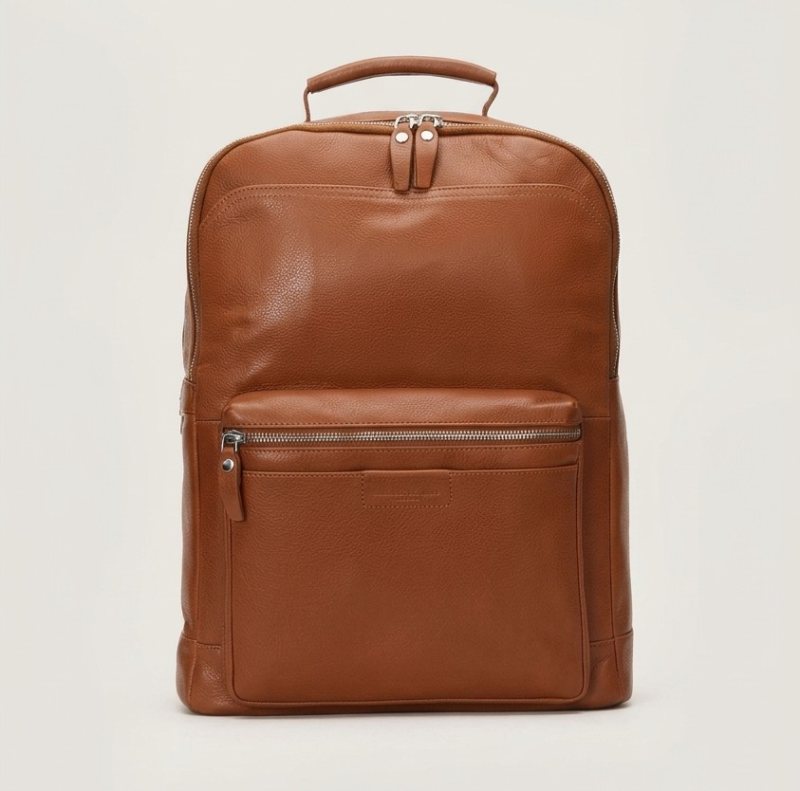 Brown leather backpack front view with zippered pocket and top handle