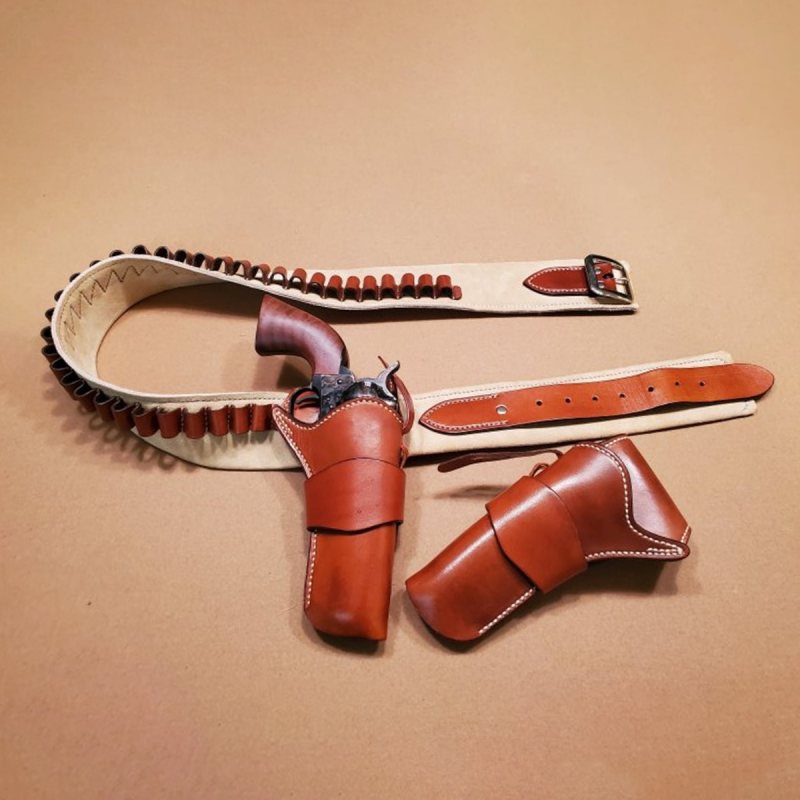 John Wayne style double single-action holster rig with suede-lined belt and .45 caliber cartridge loops laid flat