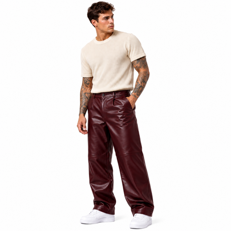 Men's burgundy leather wide-leg pants styled with cream T-shirt and white sneakers – front view